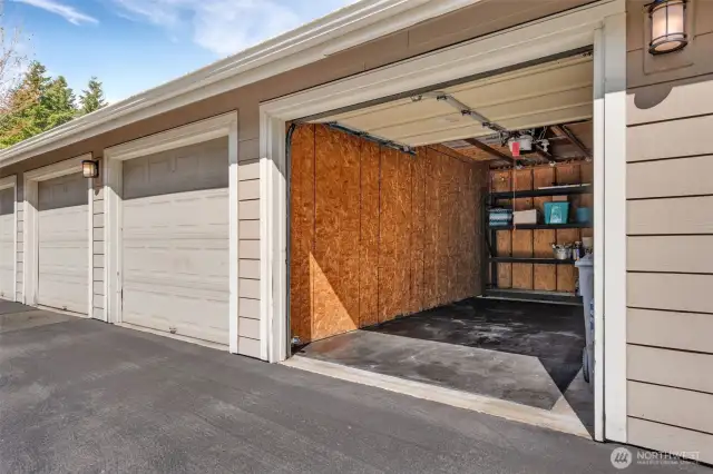 Garage with shelving is across from the unit.