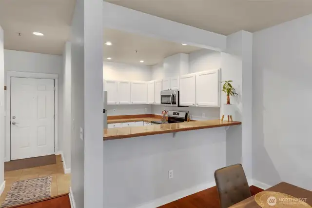 Light-filled kitchen featuring an eat-in bar