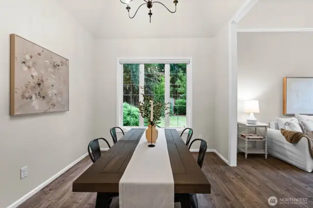 The dining space looks out to the side of the yard with plenty of trees buffering the home for a private setting.