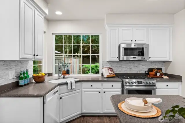 Designed for easy flow, this kitchen features updated backsplash and plenty of counter and cabinet space.