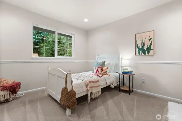 One of two guest suites on the upper floor is spacious and bright.