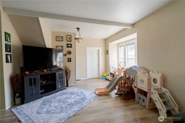 Family room facing primary bedroom and stairs to second floor.