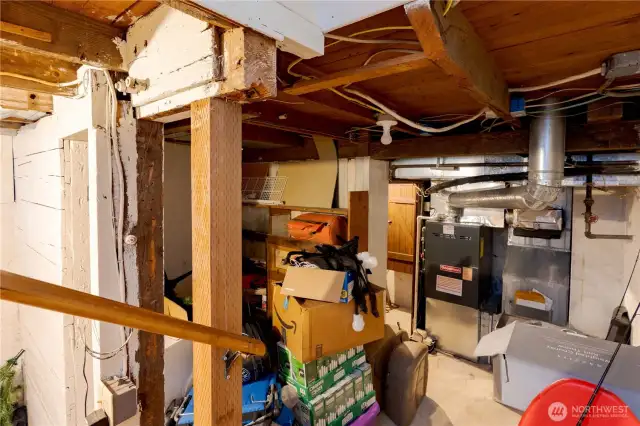 Unfinished basement with storage, crawlspace access & HVAC systems.