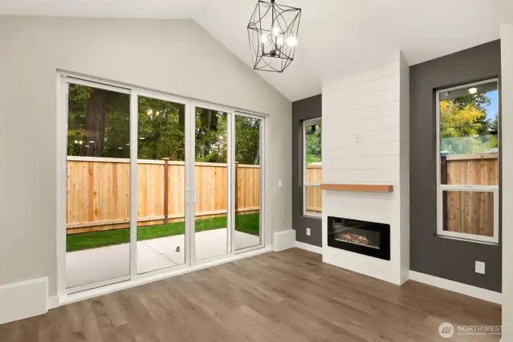 Light filled open living space with cozy fireplace.
