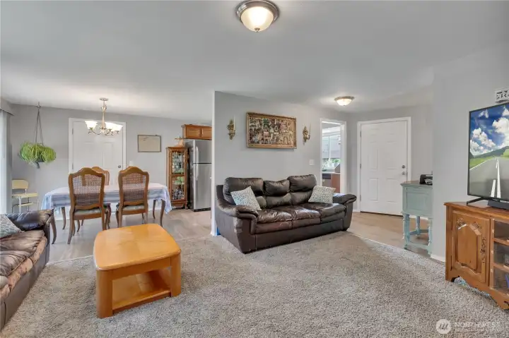 Front entry door to the right, sliding glass door to the backyard is to the left of the dining room table.