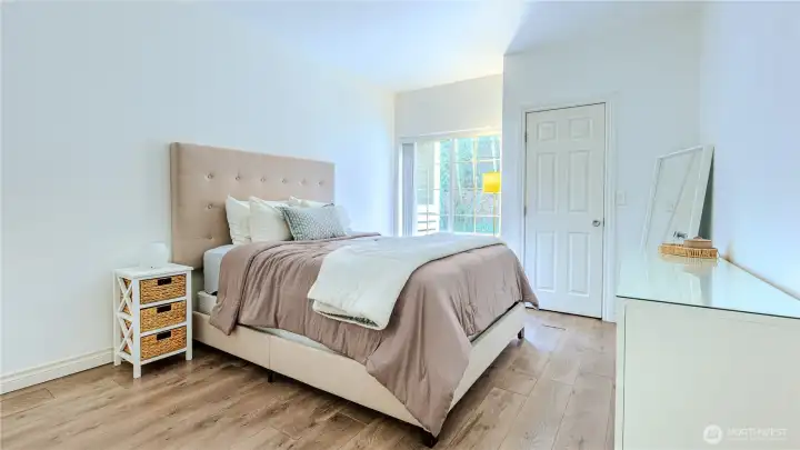Spacious primary bedroom with room for a king size bed and ample storage.