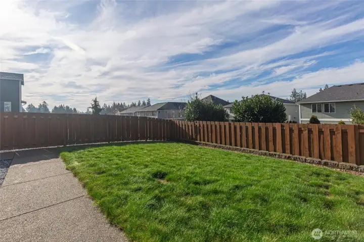 Fully fenced backyard offers privacy and security.