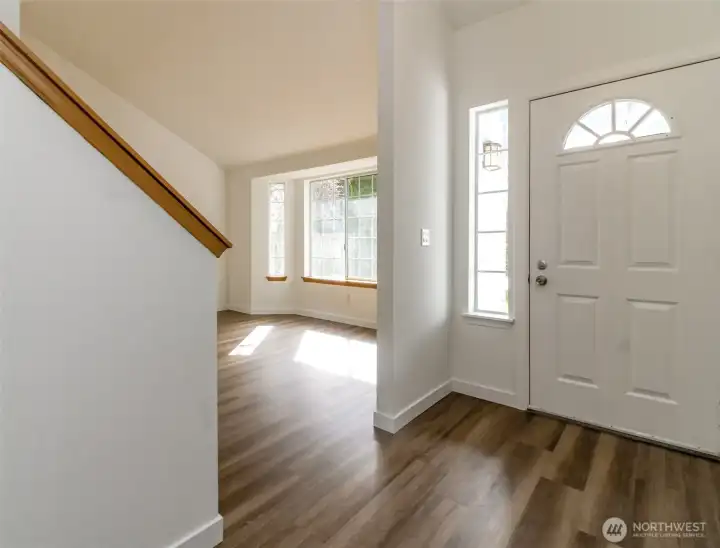 Front door looking towrds Living Room. Fresh interior Paint and new LVP flooring and carpet through-out.