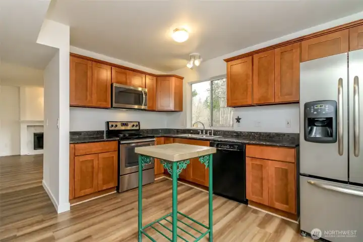 Kitchen has room for a bigger island or table/ chairs. Fresh interior Paint and new LVP flooring and carpet through-out.