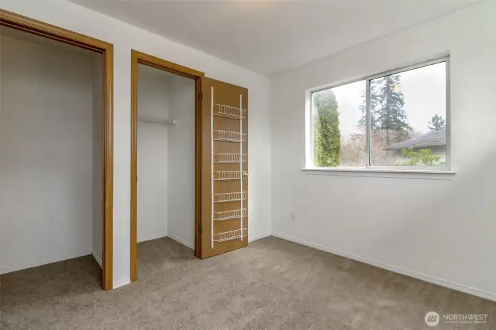 One of the upstairs bedrooms with generous closet space. Fresh interior Paint and new carpet through-out.
