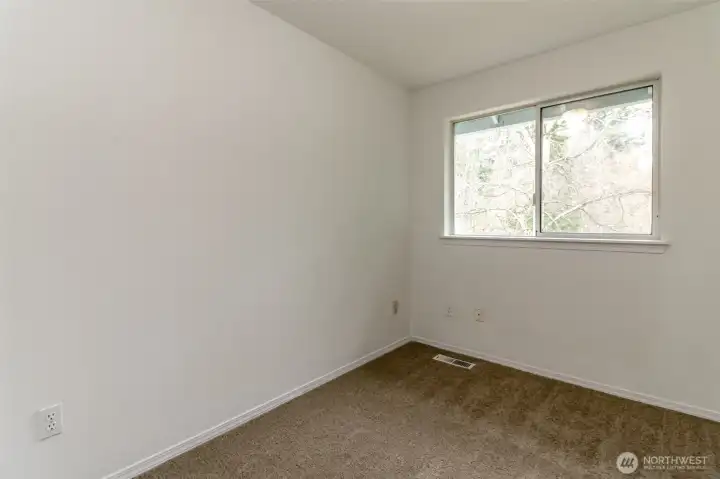 One of the upstairs bedrooms with generous closet space not pictured. Fresh interior Paint and new  carpet through-out.