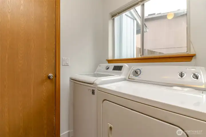 Utility room tucked in between  family room  and garage.