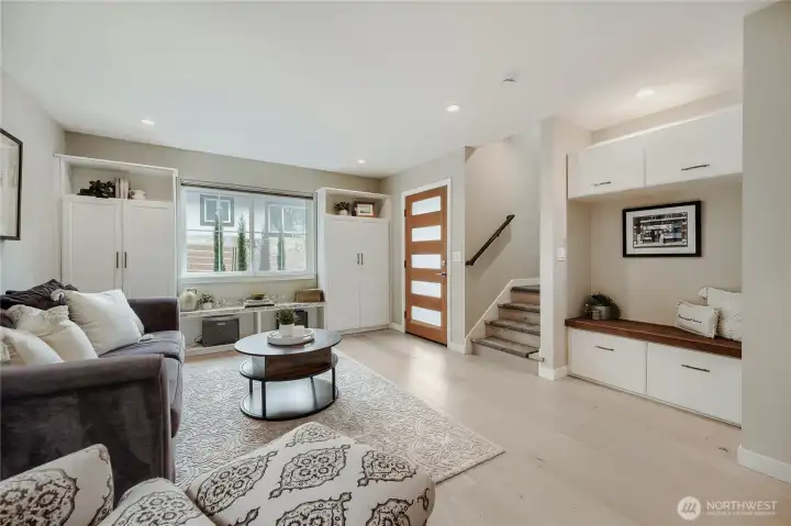 Open floor plan with hardwoods and built-in benches.