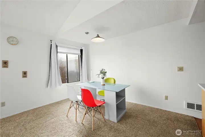 Bright dining area with large window perfect for meals or a workspace