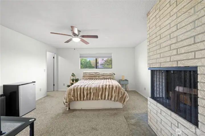 Master bedroom with wood fireplace