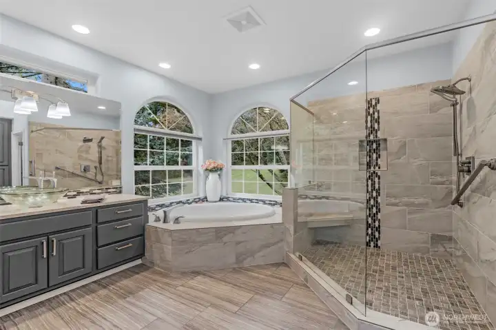 Remodeled master bath has a jetted tub, walk-in shower with multi heads, radiasnt heat in the tile floors and granite counters.