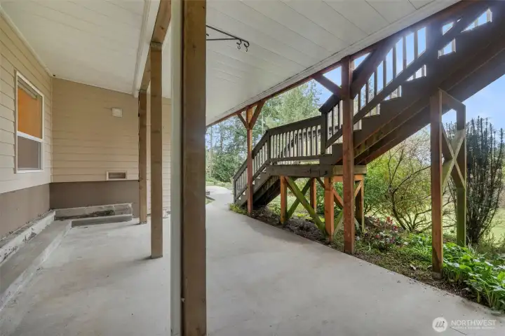 Covered patio area under the upper deck.....a good place for MIL/guests to relax in their own space out of the weather.