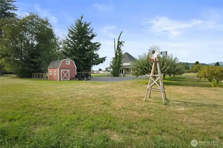 Mini barn for the hens and extra storage!  Orchard with apples, cherries, pears and plums!  Windmill does no convey.