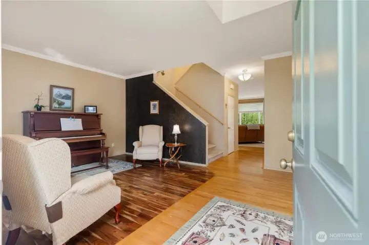 Front door opening up to a spacious entry, living room, and dining room