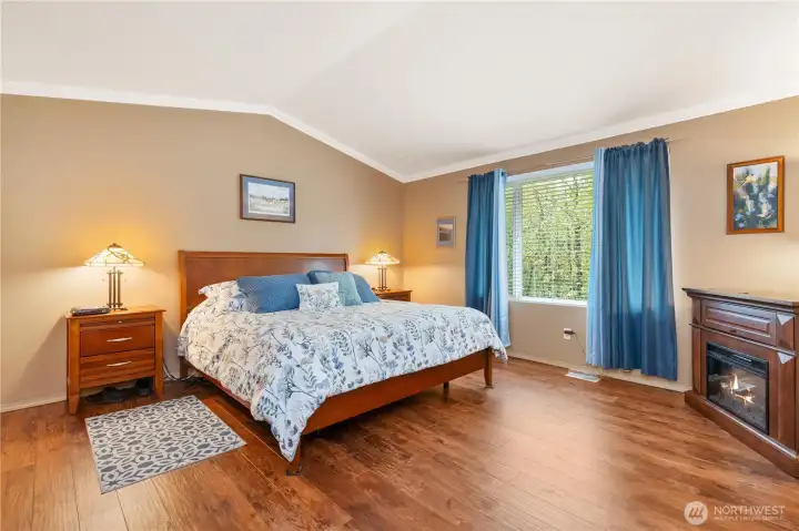 Vaulted ceilings in primary bedroom make it feel like an oasis