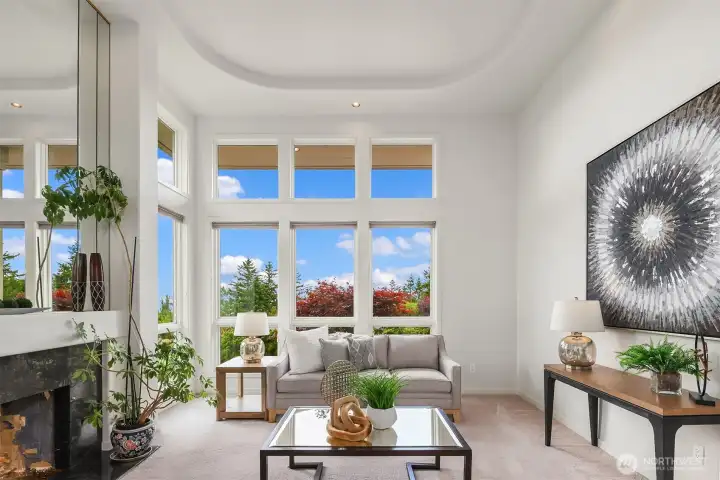 Soaring windows reveal the outstanding southwesterly views from the living room with gas fireplace Soaring windows reveal the outstanding southwesterly views from the living room with gas fireplace