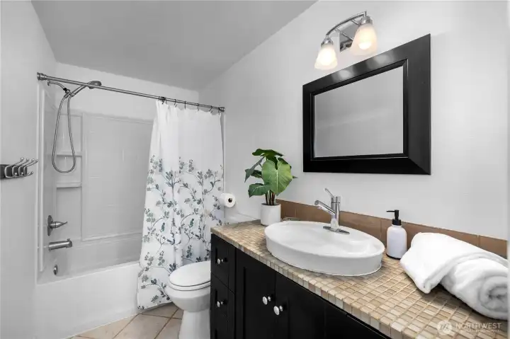 Updated bath with tile counter and above counter sink. Updated bath with tile counter and above counter sink.