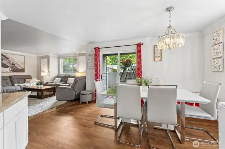 Dining area seamlessly connects to the living room and opens to a private, fenced patio through a sliding glass door. Dining area seamlessly connects to the living room and opens to a private, fenced patio through a sliding glass door.