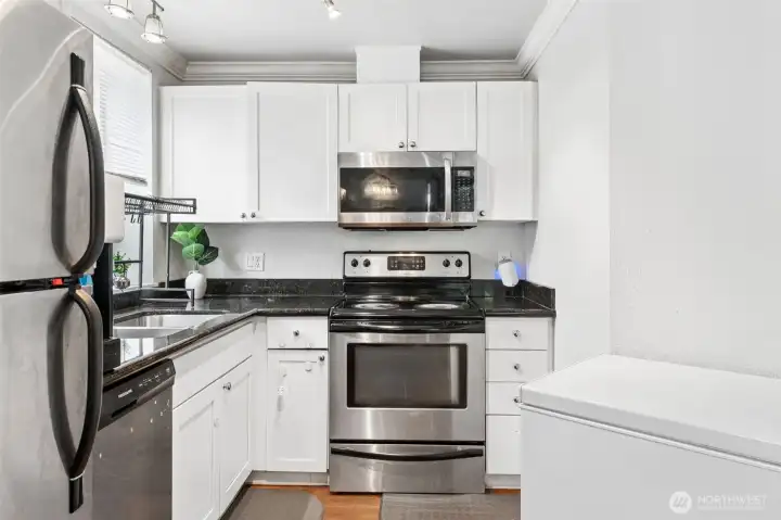 White cabinetry, stainless steel appliances, a built-in microwave, and abundant storage. Functional and bright space perfect for everyday cooking and entertaining. White cabinetry, stainless steel appliances, a built-in microwave, and abundant storage. Functional and bright space perfect for everyday cooking and entertaining.