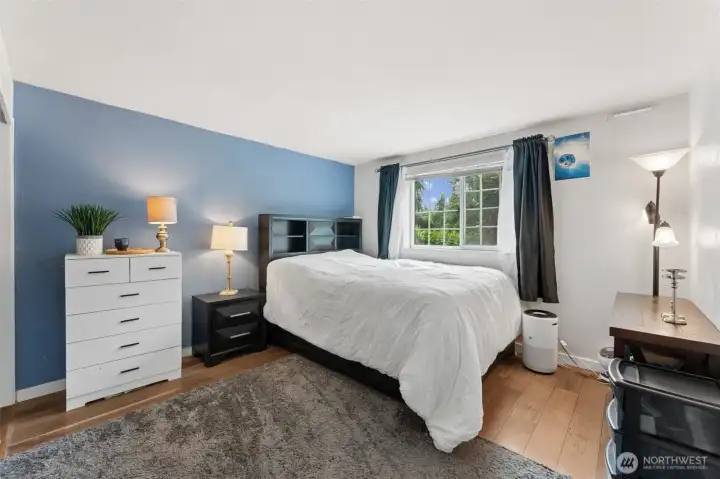 The spacious primary bedroom offers a peaceful retreat with a large picture window, abundant natural light, and generous floor space. The spacious primary bedroom offers a peaceful retreat with a large picture window, abundant natural light, and generous floor space.
