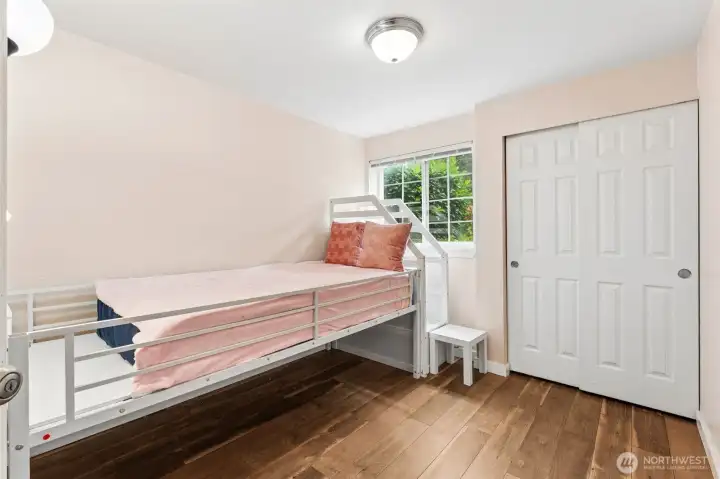 Second bedroom features a large window for abundant natural light, and a spacious closet with sliding doors. Second bedroom features a large window for abundant natural light, and a spacious closet with sliding doors.
