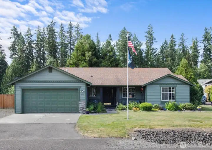 Beautiful curb appeal welcomes you home with mature landscaping, a covered front porch, and timeless Craftsman-inspired details.