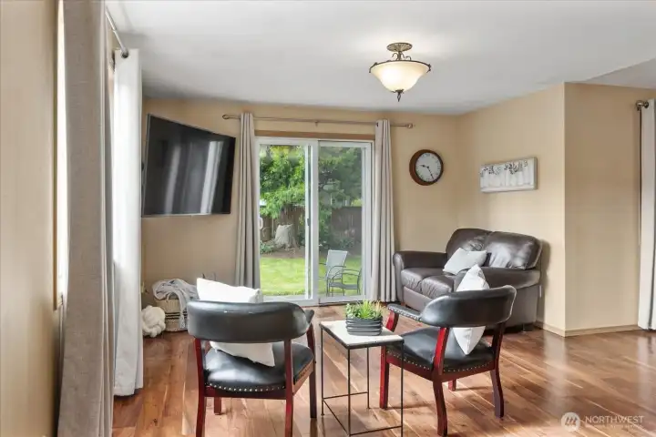 Walls of windows and a sliding glass door bring in natural light while creating an easy connection to the backyard.
