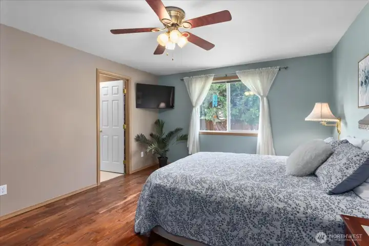 he generously sized primary bedroom offers plenty of space for a king-sized bed.