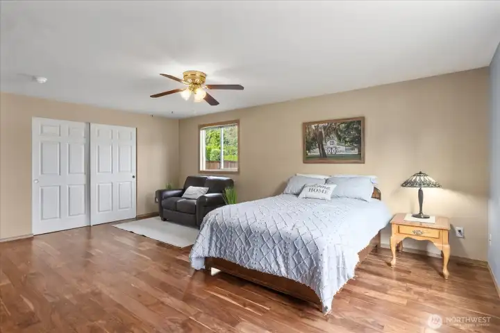 Oversized secondary bedroom with hardwood floors, abundant natural light, and plenty of room for a sitting area or home office.
