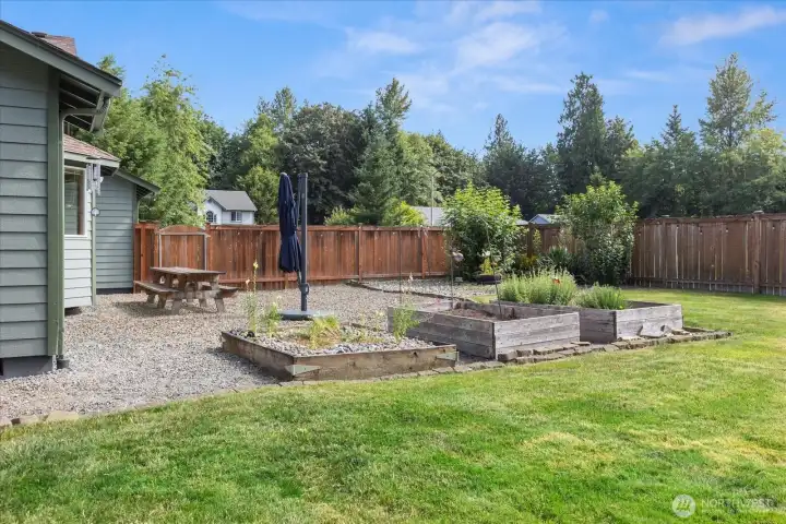 Established raised garden beds are ready for vegetables, herbs, flowers, or your next gardening project.
