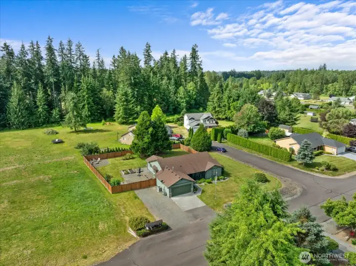 The aerial perspective highlights the generous homesite and showcases how the outdoor spaces flow around the home.