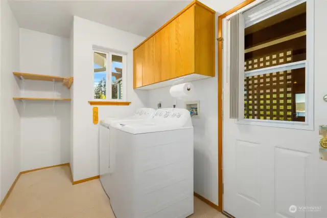 Mud room/laundry room - step out to the carport or into the kitchen from here. Full sized washer and dryer convey.