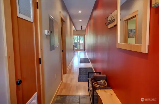 Entry, left is the utility closet and then the next door to the left is the bedroom, beyond is the great room and then the porch with the river view.