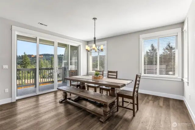 Dining area opens through 4 large panel sliding glass doors to the view scaped balcony.