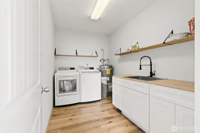 Large utility room with side by side w/d, utility sink, and ample storage