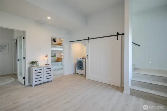 View of utility closet and stairs to second floor where the Great Room and Primary Suite are located.