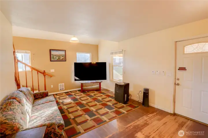 From the kitchen looking into the living room (Open Concept). Door on right leads to the DogDeck and DogYard.