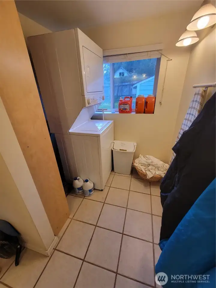 Laundry area just inside front door and to the right.