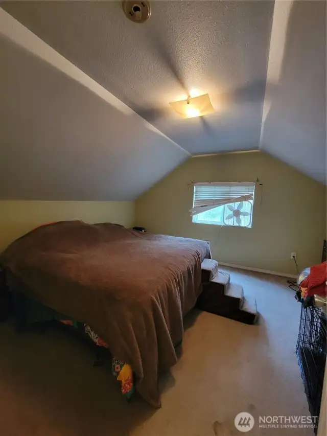 The third bedroom, on the upper level, used as the Primary Bedroom.