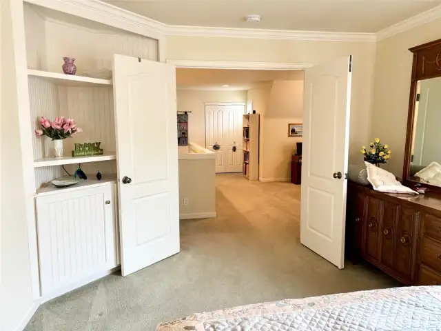 The primary bedroom includes double doors and built-in casework.