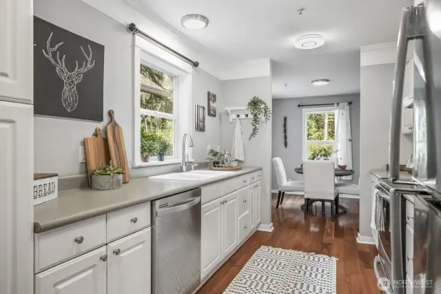 The kitchen features sleek stainless steel appliances, offering both modern style and high-end functionality for everyday cooking and entertaining.
