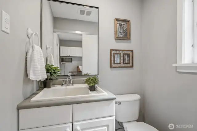 A convenient 1/2 bath located just off the kitchen and laundry room, perfect for guests and easy access from the main living areas.