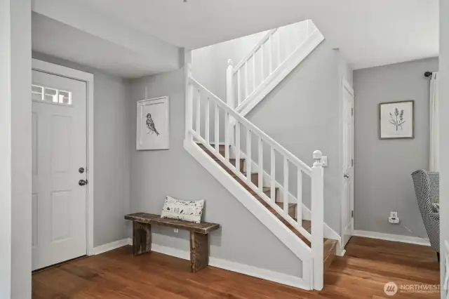 The staircase is complemented by a convenient storage closet underneath, offering extra space for organizing household items.