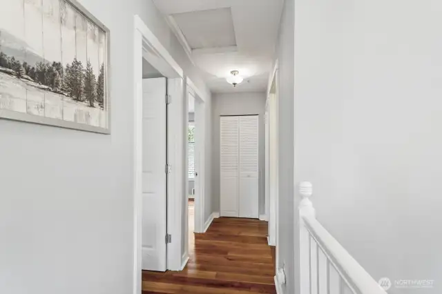 Warm cherry hardwoods continue through bedrooms and hallway.