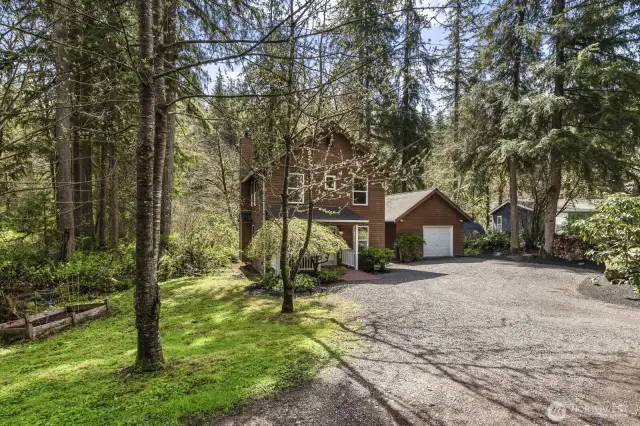 Expansive and well-maintained private driveway provides ample parking for multiple vehicles, with generous space for an RV, trailer, or guest parking.